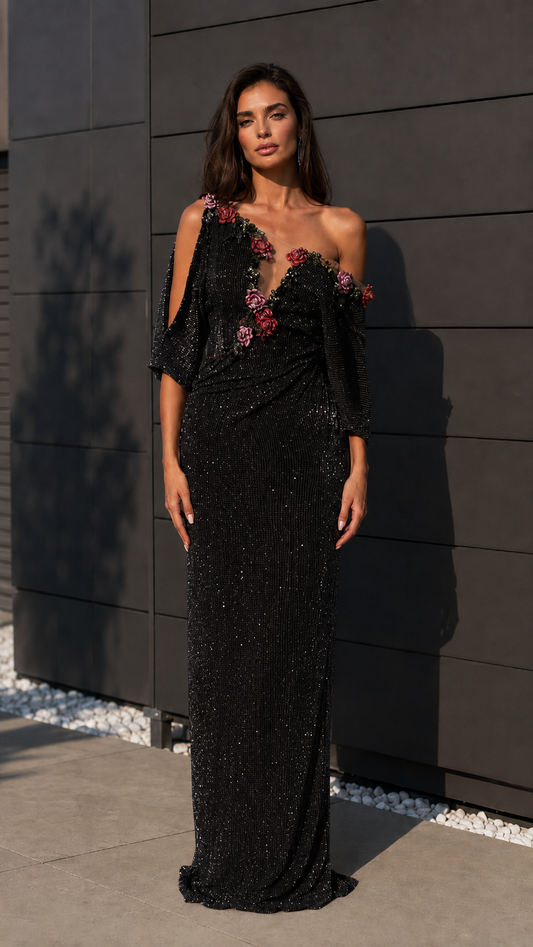 Black one-shoulder sequin evening gown with floral appliqué and draped waist front view