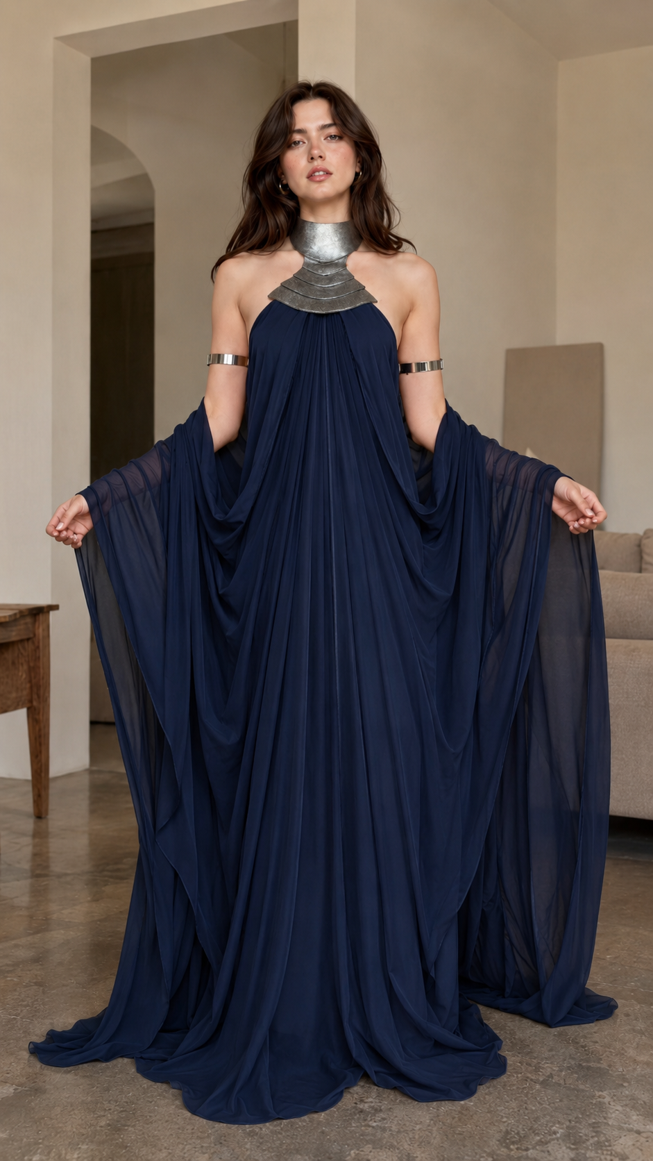 Front view of navy halter cape maxi gown with metallic-look neckline detail