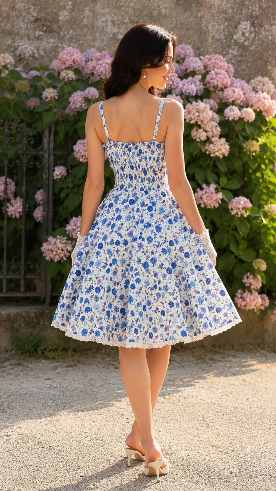 Back view of blue floral midi sundress with smocked bodice and flared skirt