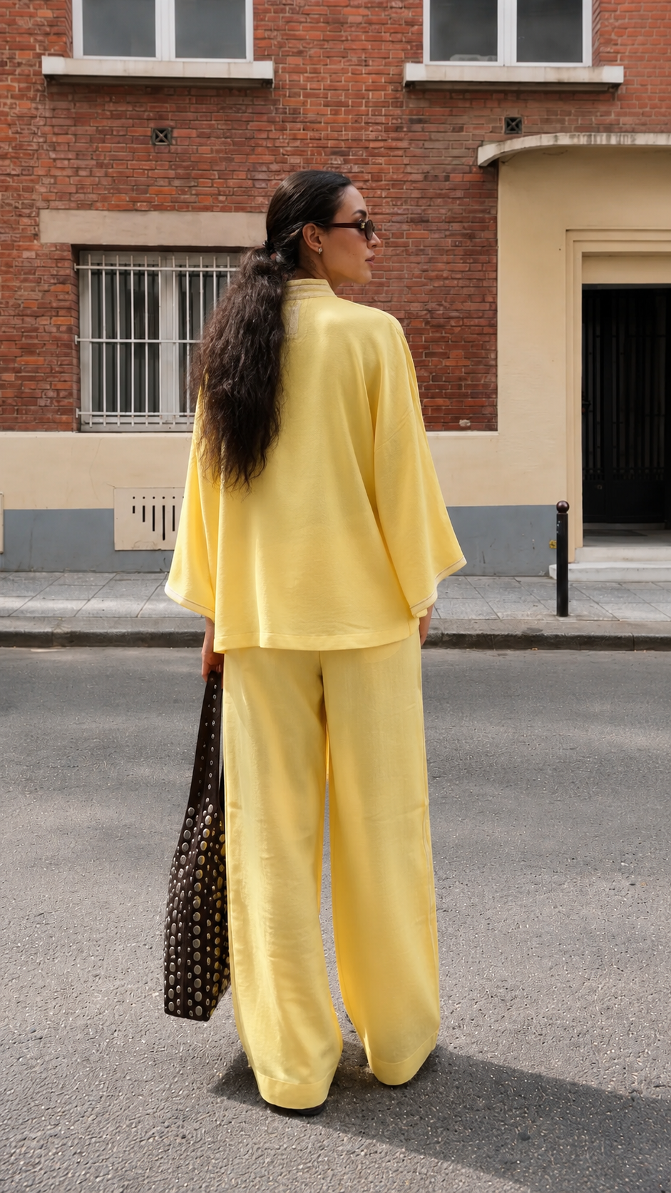 Back view of butter yellow relaxed two-piece tunic and wide-leg pants set