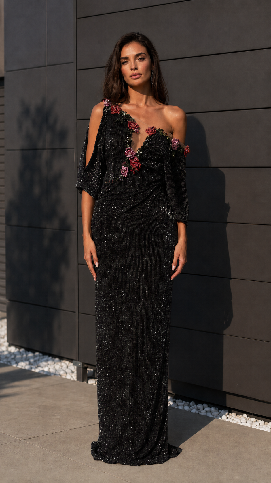 Black one-shoulder sequin evening gown with floral appliqué and draped waist front view