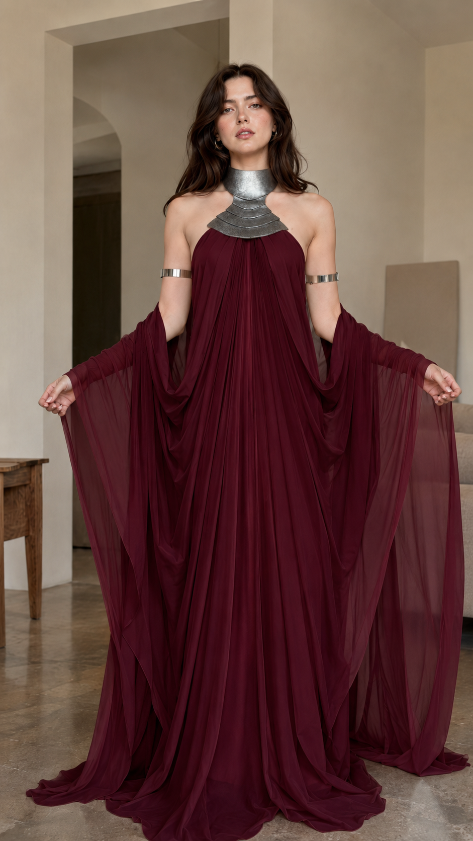 Front view of burgundy flowing evening gown with sheer draped sides