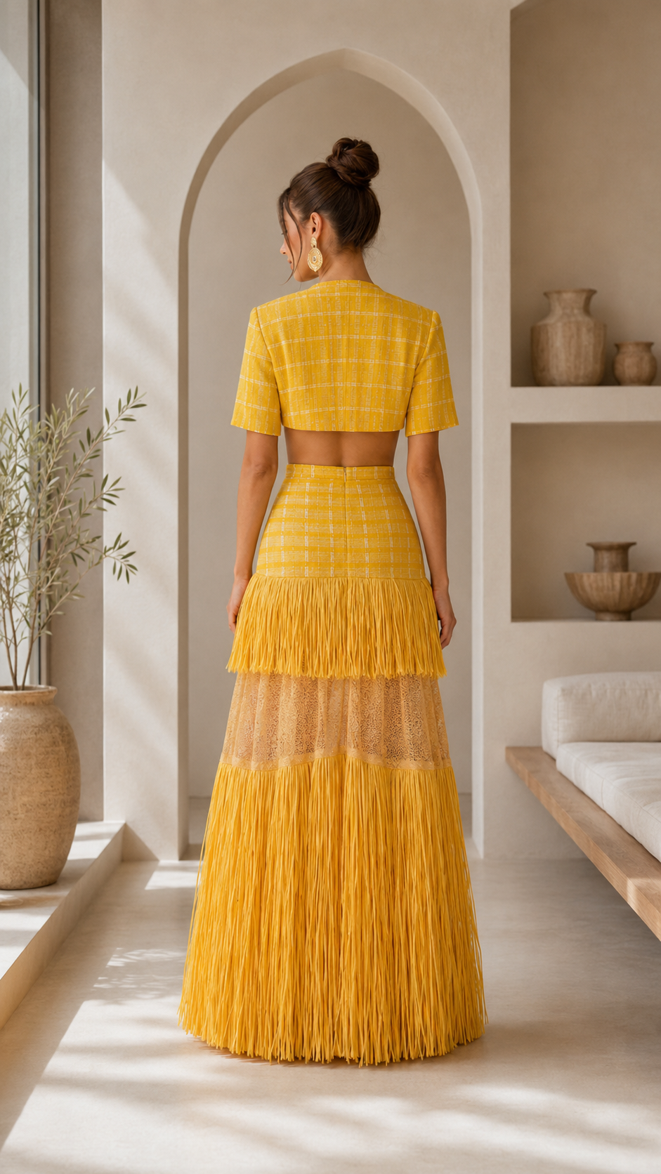 Back view of sunflower yellow two-piece maxi skirt set with fringe hem