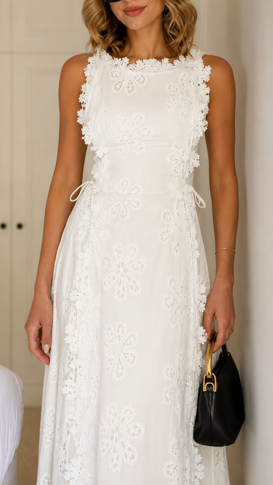 Close-up of white floral lace maxi dress bodice and side-tie waist detail