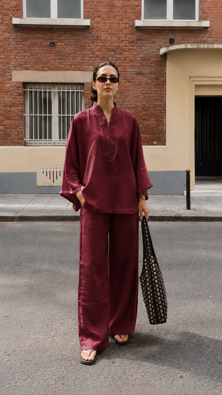 Model wearing a burgundy relaxed tunic and wide-leg pants coordinated set