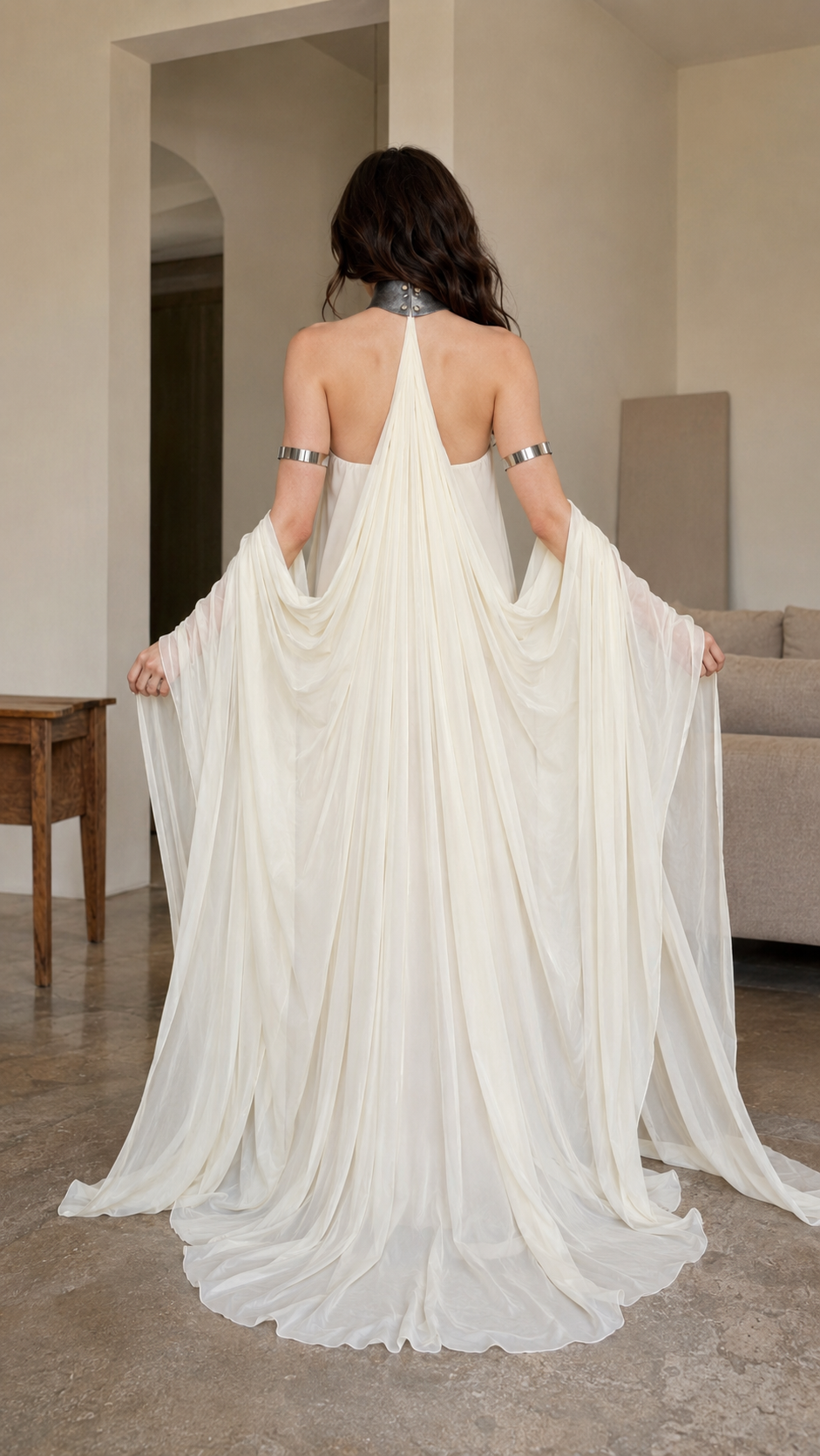 Back view of ivory halter maxi gown with open back and flowing train