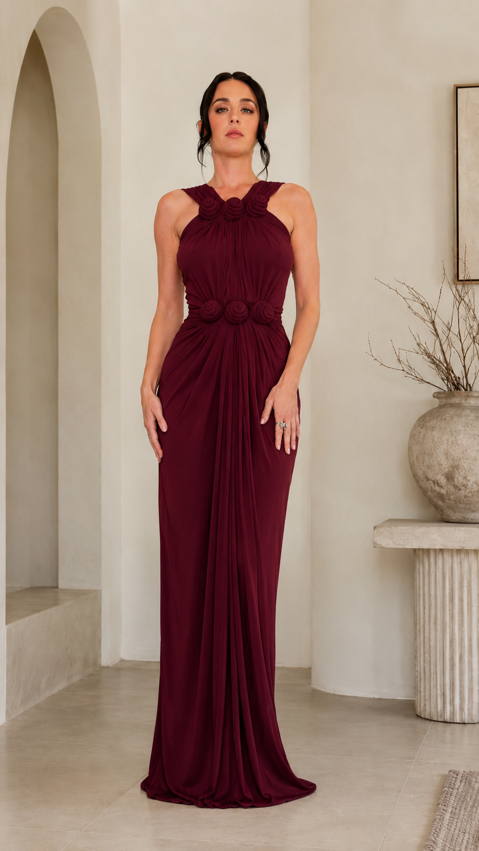 Front view of burgundy rosette halter ruched formal gown