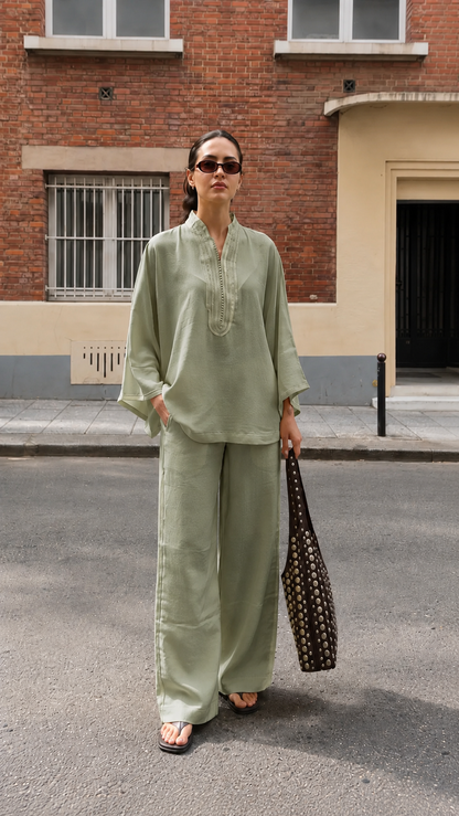 Model wearing a sage green embroidered tunic and wide-leg pants matching set